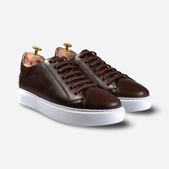 Elegant full-angle view of handcrafted brown leather sneakers with white soles by Shoescoo.