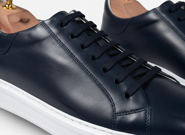 Clean low-top profile of Elegante navy leather sneakers — minimal dress sneakers for men, smart-casual style