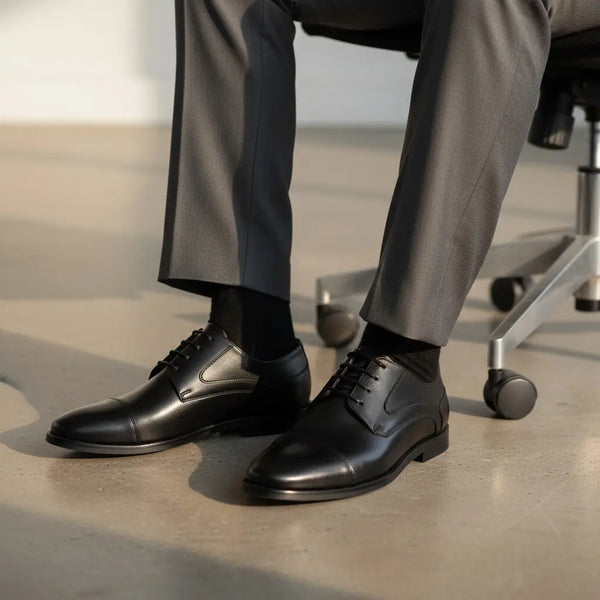 Regal Derby black leather derby shoes styled with a tailored suit—ideal business-formal footwear for men.
