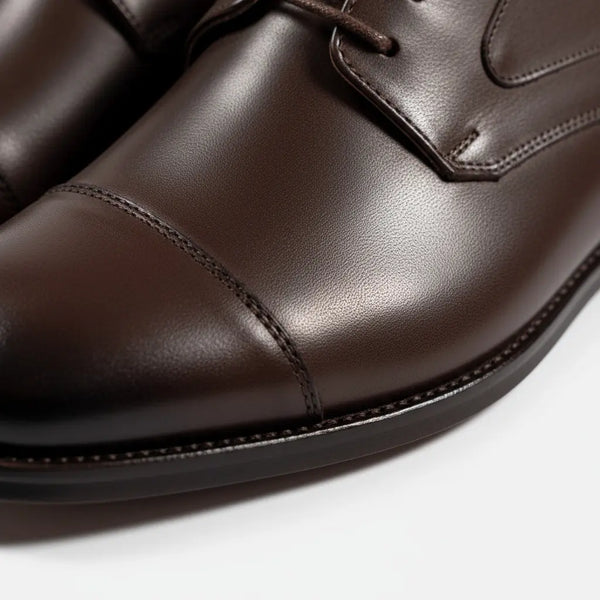 Close-up of full-grain brown leather — premium craftsmanship on Regal Derby Goodyear welt derby shoes.