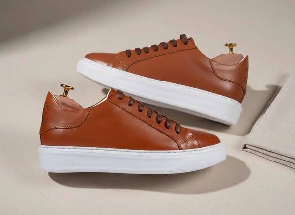 Close-up of men’s tan leather sneakers showing smooth full-grain texture and hand-finished stitching — premium handcrafted sneakers for everyday wear.