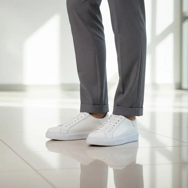 Men’s white leather sneakers styled with business-casual outfit — minimalist design that elevates office and smart-casual looks.