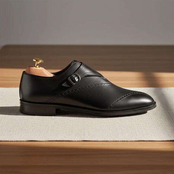 Clean side profile of Sovereign black monk strap shoes — single monk strap with polished finish.