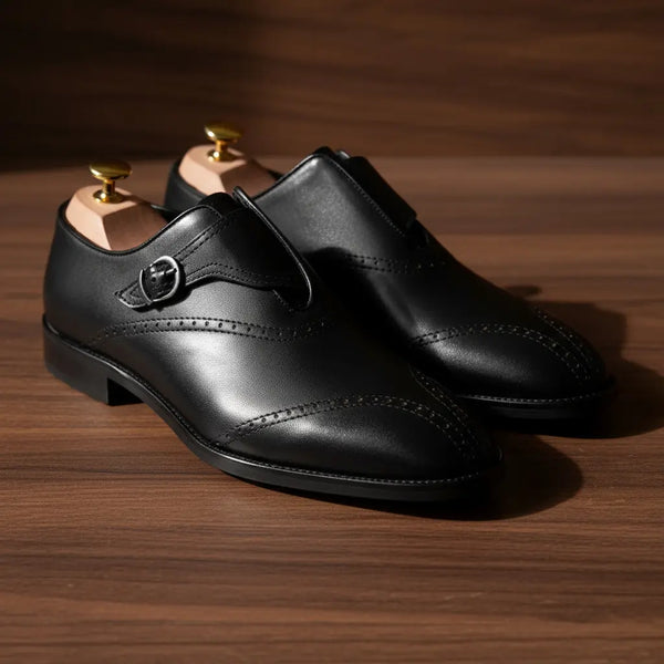 Close-up of Sovereign black monk strap shoes — full-grain leather texture and hand-polished finish.