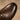 Close-up detail of brown leather derby shoe cap-toe and patina.