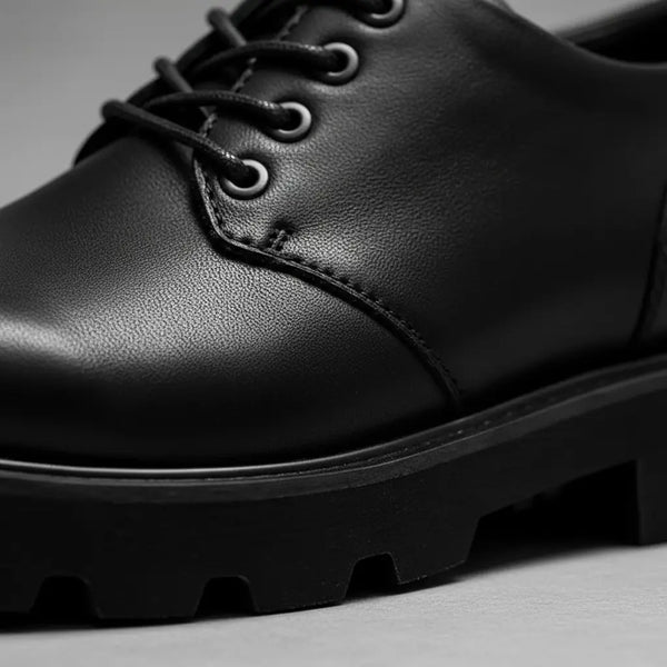 Close-up of Urban Command Derby full-grain black leather with refined Goodyear welt stitching.
