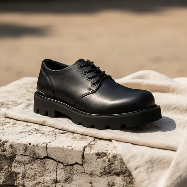 Minimal solo shot of Urban Command black lug sole derby shoes on a stone surface, showing clean silhouette and rugged outsole.