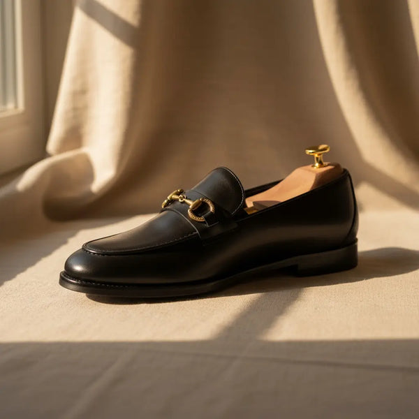Minimal studio shot of Vanguard Black leather dress loafers — refined handcrafted design.