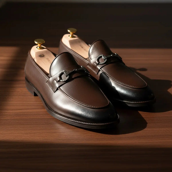 Close-up of Vanguard brown leather loafers for men — full-grain leather texture with hand-polished finish.